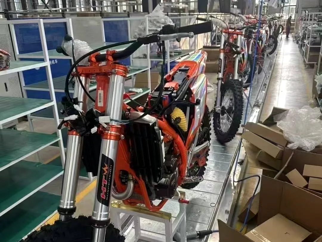FCDC Motor assembly workstation with motorcycle and export cartons nearby