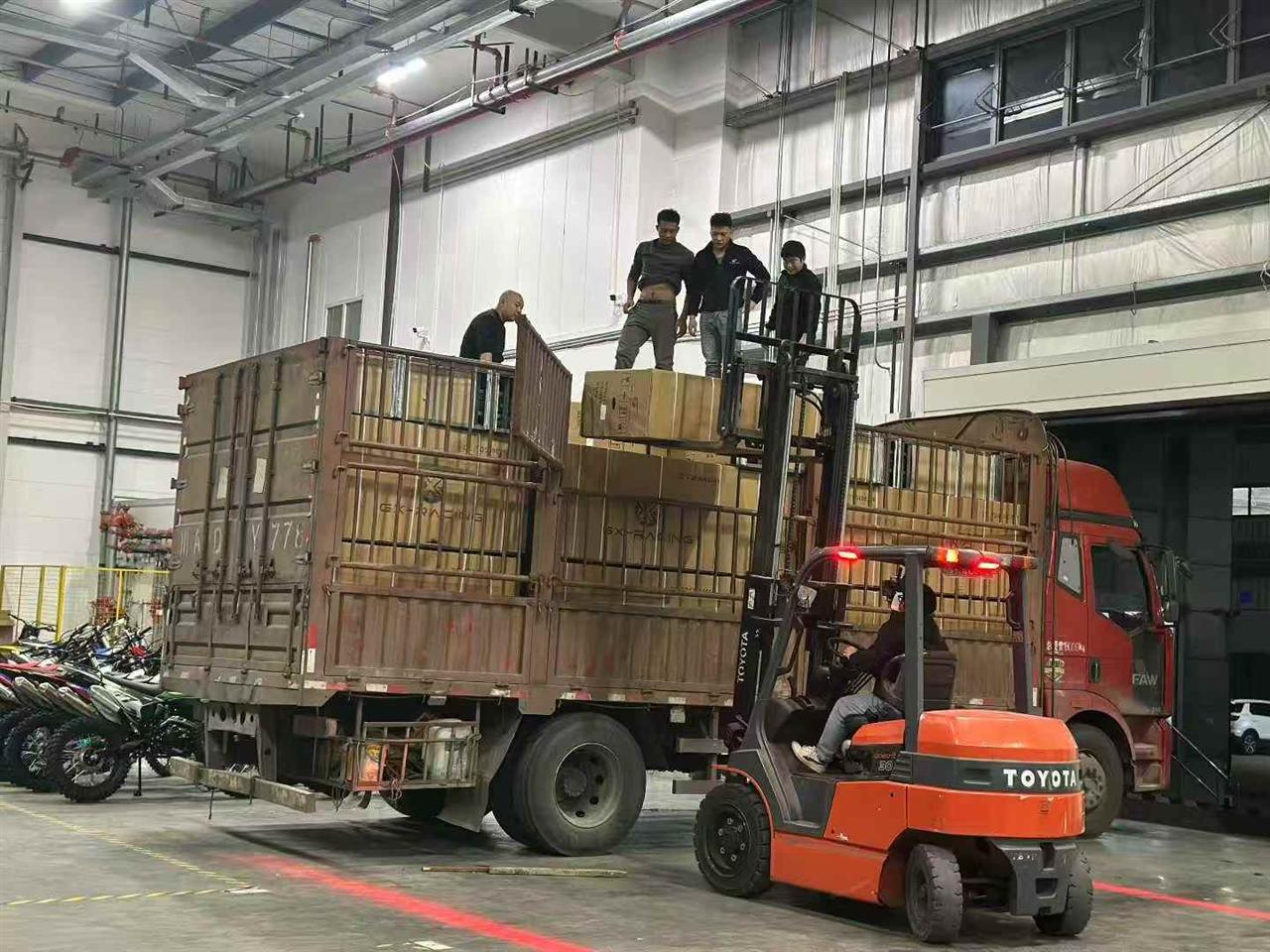 FCDC Motor factory team loading packed motorcycle cargo with forklift support
