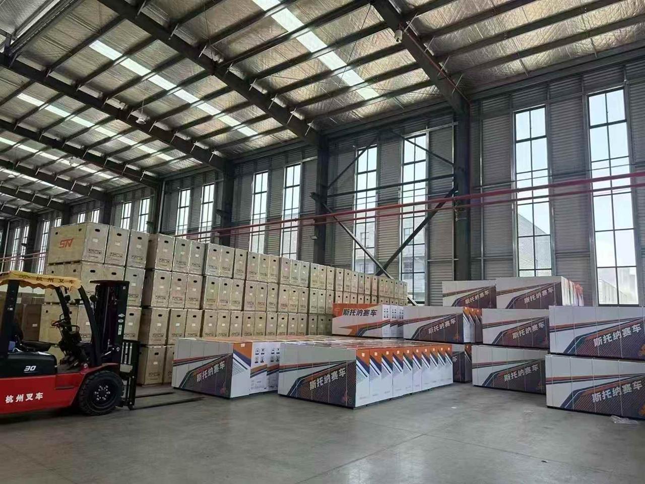FCDC Motor warehouse dispatch area with packed motorcycle cartons and forklift