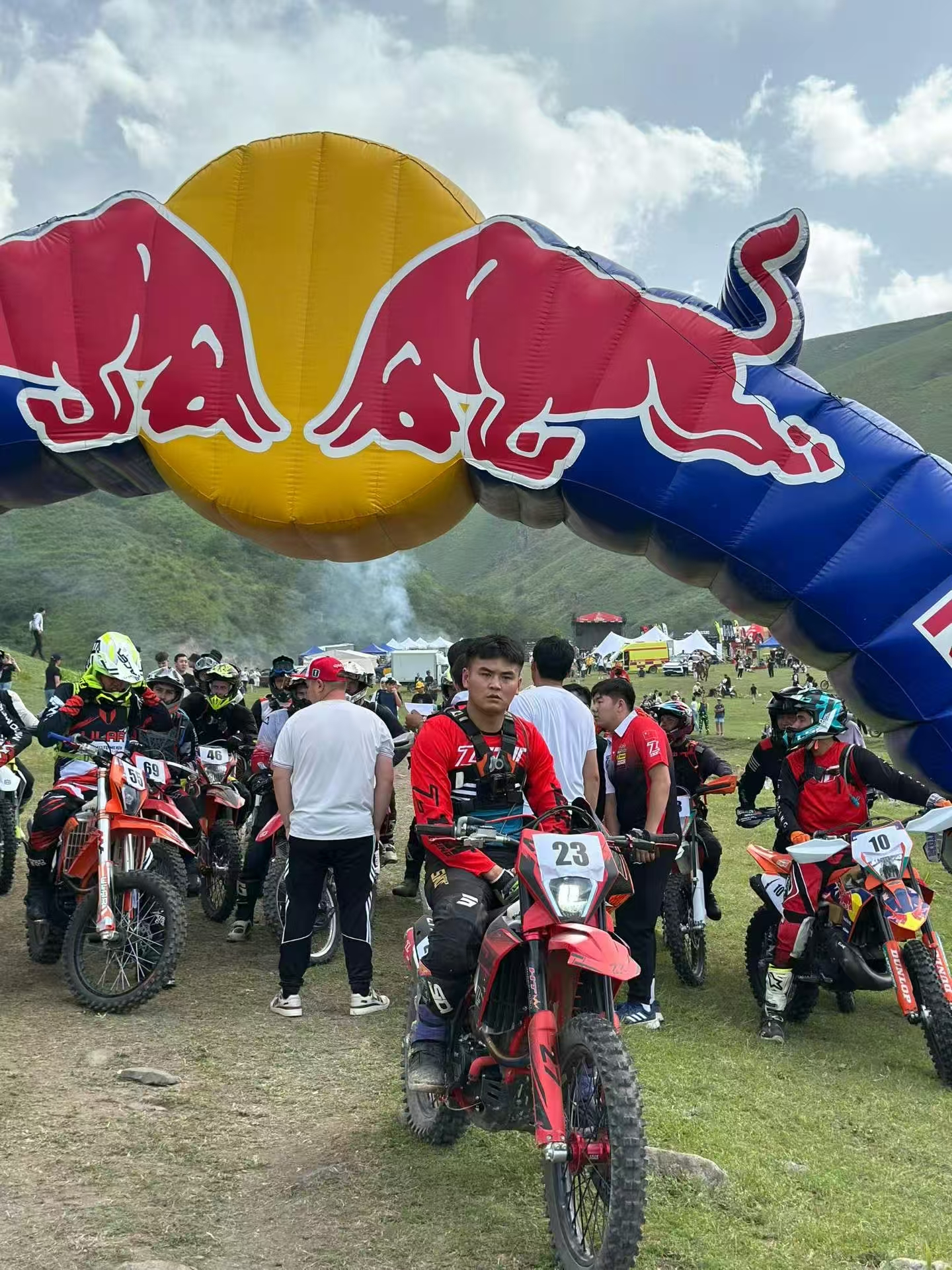 Riders waiting under Red Bull arch at Kazakhstan motorcycle festival