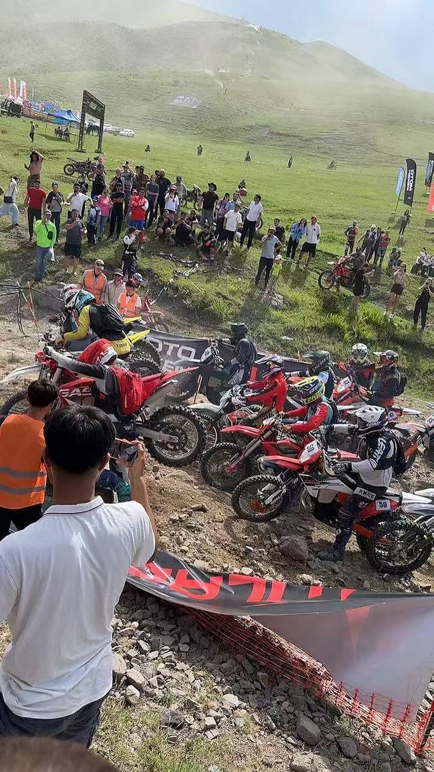 Motorcycle festival hill section with multiple riders